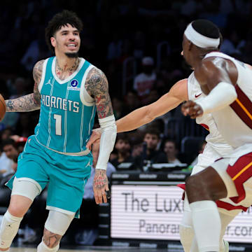 Oct 28, 2025; Miami, Florida, USA; Charlotte Hornets guard LaMelo Ball (1) dribbles the basketball as Miami Heat center Bam Adebayo (13) defends during the second quarter at Kaseya Center. Mandatory Credit: Sam Navarro-Imagn Images