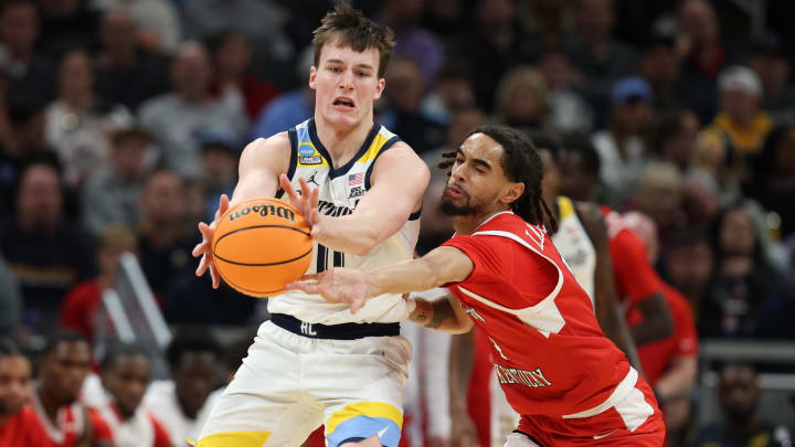 Mar 22, 2024; Indianapolis, IN, USA; Marquette Golden Eagles guard Tyler Kolek (11) controls the ball against Western Kentucky Hilltoppers guard Khristian Lander (4) in the first half in the first round of the 2024 NCAA Tournament at Gainbridge FieldHouse. Mandatory Credit: Trevor Ruszkowski-USA TODAY Sports