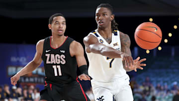 Nov 27, 2024; Paradise Island, Bahamas, BHS; West Virginia Mountaineers guard Javon Small (7) passes the ball as Gonzaga Bulldogs guard Nolan Hickman (11) defends during the first half at the Atlantis Resort.  Mandatory Credit: Kevin Jairaj-Imagn Images