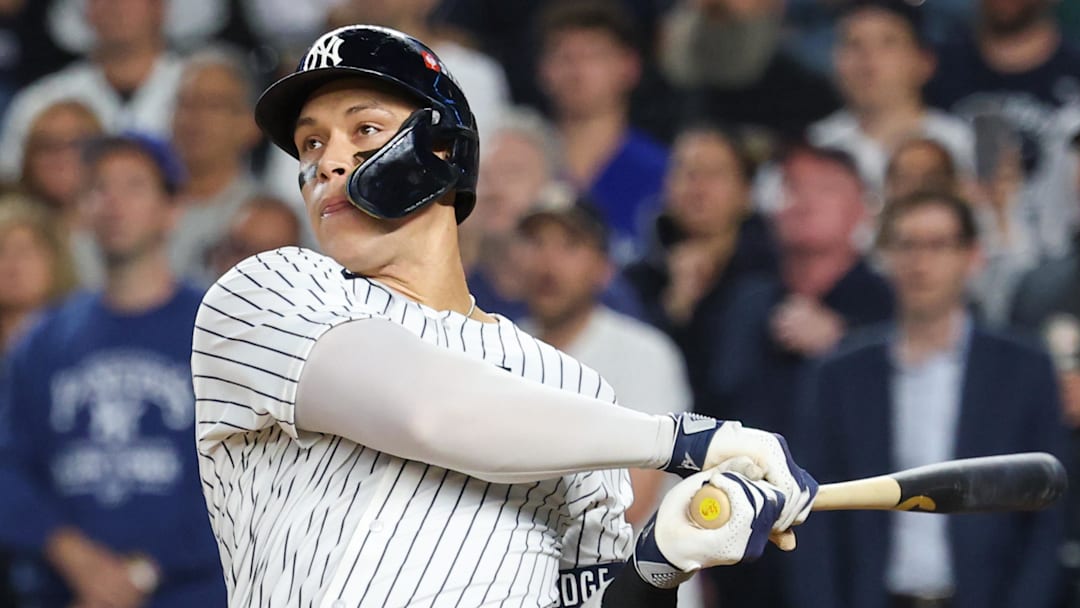 Oct 7, 2025; Bronx, New York, USA; New York Yankees outfielder Aaron Judge (99) hits a three-run home run in the fourth inning against the Toronto Blue Jays during game three of the ALDS round for the 2025 MLB playoffs at Yankee Stadium. Mandatory Credit: Vincent Carchietta-Imagn Images