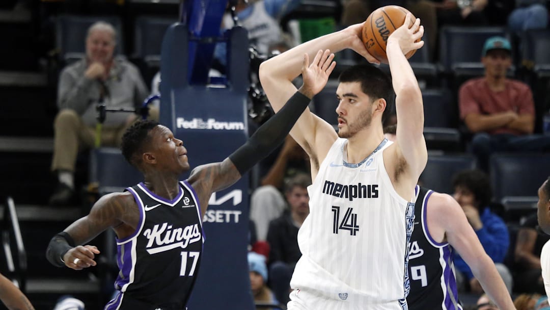 Nov 20, 2025; Memphis, Tennessee, USA; Memphis Grizzlies center Zach Edey (14) handles the ball as Sacramento Kings guard Dennis Schroder (17) defends during the second quarter at FedExForum. Mandatory Credit: Petre Thomas-Imagn Images