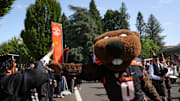 Benny Beaver high fives graduates during the processional of the Oregon State University 2025 commencement ceremony at Reser Stadium on Saturday, June 14, 2025 in Corvallis.