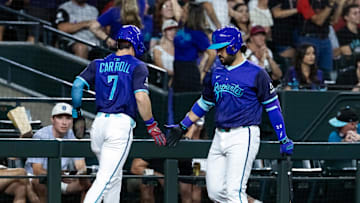 Jun 13, 2025; Phoenix, Arizona, USA; Arizona Diamondbacks outfielder Corbin Carroll (7) celebrates with teammate Eugenio Suarez after scoring in the third inning against the San Diego Padres at Chase Field. Mandatory Credit: Mark J. Rebilas-Imagn Images