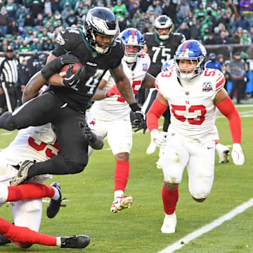 Jan 5, 2025; Philadelphia, Pennsylvania, USA; New York Giants safety Jason Pinnock (27) and linebacker Boogie Basham (55) stop Philadelphia Eagles running back Kenneth Gainwell (14) during the fourth quarter at Lincoln Financial Field. Mandatory Credit: Eric Hartline-Imagn Images
