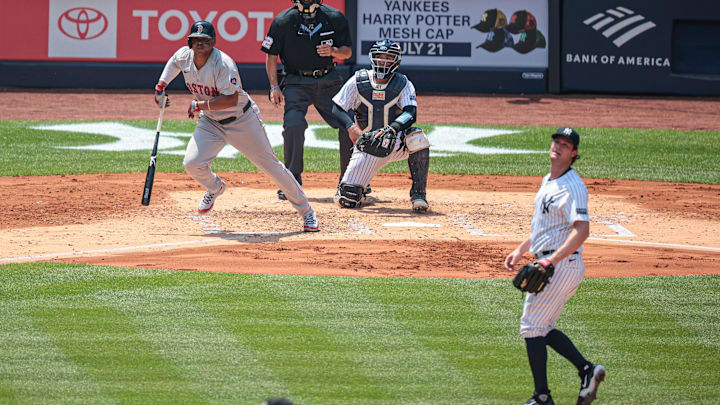 Jul 6, 2024; Bronx, New York, USA; Boston Red Sox third baseman Rafael Devers (11) hits an RBI single during the third inning against New York Yankees starting pitcher Gerrit Cole (45) at Yankee Stadium. Mandatory Credit: Vincent Carchietta-Imagn Images