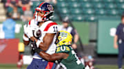 Jun 14, 2024; Edmonton, Alberta, CAN; Montreal Alouettes wide receiver Kaion Julien-Grant (11) catches a ball in front of Edmonton Elks during the first half at Commonwealth Stadium. Mandatory Credit: Perry Nelson-Imagn Images