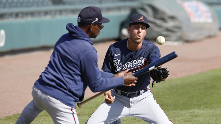 Mar 12, 2020; Lakeland, Florida, USA;  Atlanta Braves coach Ron Washington hits balls at infielder AJ Graffanino (right) during batting practice before the game against the Detroit Tigers at Publix Field at Joker Marchant Stadium. Mandatory Credit: Reinhold Matay-Imagn Images
