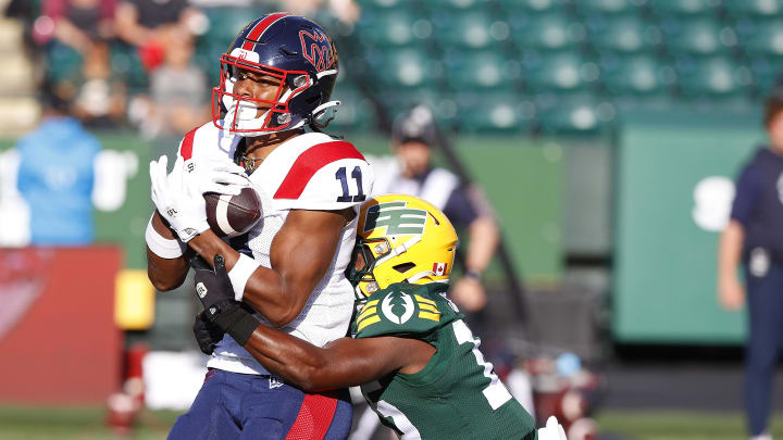 Jun 14, 2024; Edmonton, Alberta, CAN; Montreal Alouettes wide receiver Kaion Julien-Grant (11) catches a ball in front of Edmonton Elks during the first half at Commonwealth Stadium. Mandatory Credit: Perry Nelson-USA TODAY Sports