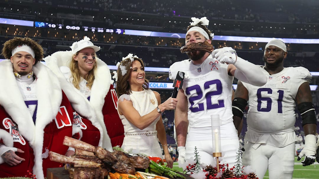 Dec 25, 2025; Minneapolis, Minnesota, USA; Minnesota Vikings safety Harrison Smith (22) eats a steak after the game against the Detroit Lions while being interviewed by Dianna Russini at U.S. Bank Stadium. Mandatory Credit: Matt Krohn-Imagn Images