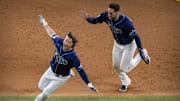 Oct 24, 2020; Arlington, Texas, USA; The Tampa Bay Rays center fielder Kevin Kiermaier (39) and right fielder Brett Phillips (14) celebrate Phillips hitting the game winning two run walk off single against the Los Angeles Dodgers during the ninth inning in game four of the 2020 World Series at Globe Life Field. Mandatory Credit: Jerome Miron-Imagn Images