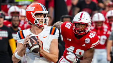 Sep 20, 2024; Lincoln, Nebraska, USA; Illinois Fighting Illini quarterback Luke Altmyer (9) drops to throw against Nebraska Cornhuskers linebacker MJ Sherman (48) during the first quarter at Memorial Stadium. Mandatory Credit: Dylan Widger-Imagn Images