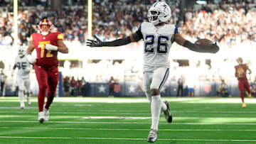 Oct 19, 2025; Arlington, Texas, USA; Dallas Cowboys cornerback Daron Bland (26) carries the ball after an interception for a touchdown against the Washington Commanders during the third quarter of the game at AT&T Stadium. Mandatory Credit: Kevin Jairaj-Imagn Images