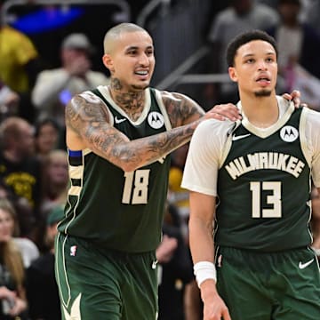 Oct 30, 2025; Milwaukee, Wisconsin, USA; Milwaukee Bucks guard Ryan Rollins (13) celebrates with forward Kyle Kuzma (18) after beating the Golden State Warriors as Warriors forward Jimmy Butler (10) looks on at Fiserv Forum. Mandatory Credit: Benny Sieu-Imagn Images