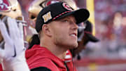 Christian McCaffrey watches from the sideline due to injury against the New York Jets.