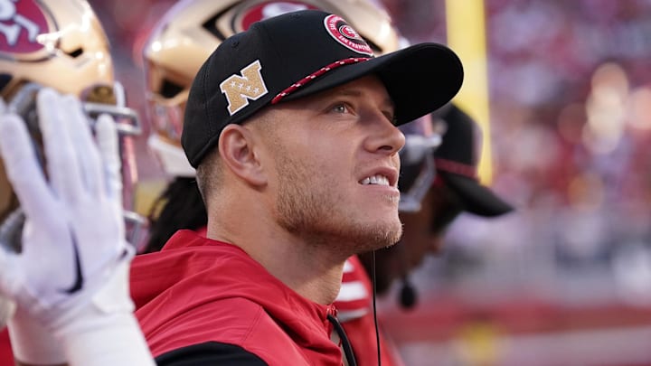 Christian McCaffrey watches from the sideline due to injury against the New York Jets.