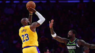 Apr 30, 2025; Los Angeles, California, USA; Los Angeles Lakers forward LeBron James (23) shoots against Minnesota Timberwolves forward Julius Randle (30) during the second half in game five of first round for the 2025 NBA Playoffs at Crypto.com Arena. Mandatory Credit: Gary A. Vasquez-Imagn Images