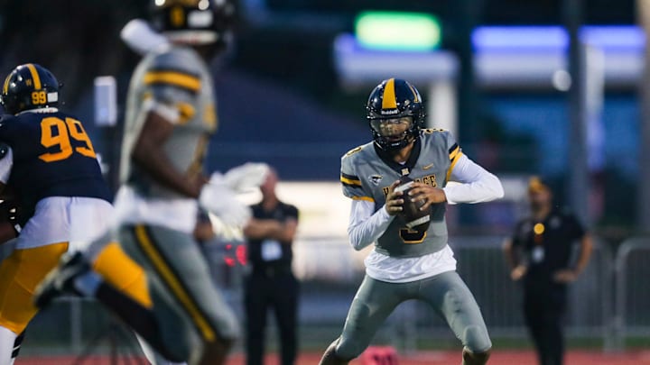 American Heritage quarterback Dia Bell (3) scrambles in the backfield during the first quarter of a game against Naples last September. Bell last week threw for more than 100 yards and two touchdowns to lead the Patriots past Hollywood McArthur, 23-14, in a preseason Kickoff Classic game.