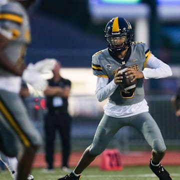 American Heritage Patriots quarterback Dia Bell (3) scrambles in the backfield during the first quarter of a game against the Naples Golden Eagles at Staver Field in Naples on Friday, Sept. 13, 2024.