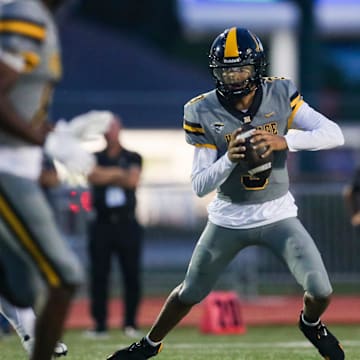 American Heritage Patriots quarterback Dia Bell (3) scrambles in the backfield during the first quarter of a game against the Naples Golden Eagles at Staver Field in Naples on Friday, Sept. 13, 2024.