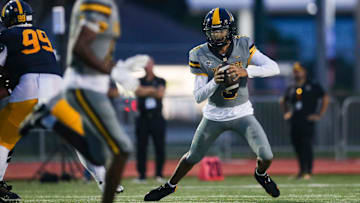 American Heritage Patriots quarterback Dia Bell (3) scrambles in the backfield during the first quarter of a game against the Naples Golden Eagles at Staver Field in Naples on Friday, Sept. 13, 2024.