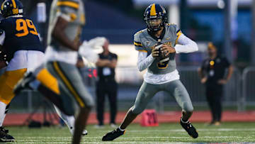 American Heritage Patriots quarterback Dia Bell (3) scrambles in the backfield during the first quarter of a game against the Naples Golden Eagles at Staver Field in Naples on Friday, Sept. 13, 2024.