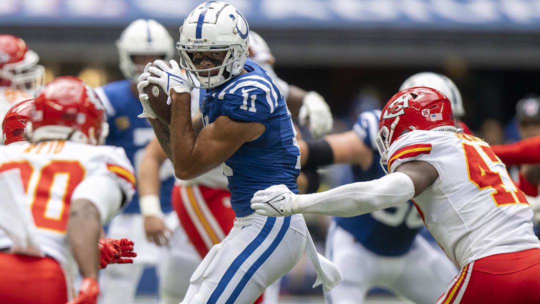 Sep 25, 2022; Indianapolis, Indiana, USA; Indianapolis Colts wide receiver Michael Pittman Jr. (11) catches a pass in front of Kansas City Chiefs linebacker Darius Harris (47) during the second quarter at Lucas Oil Stadium.