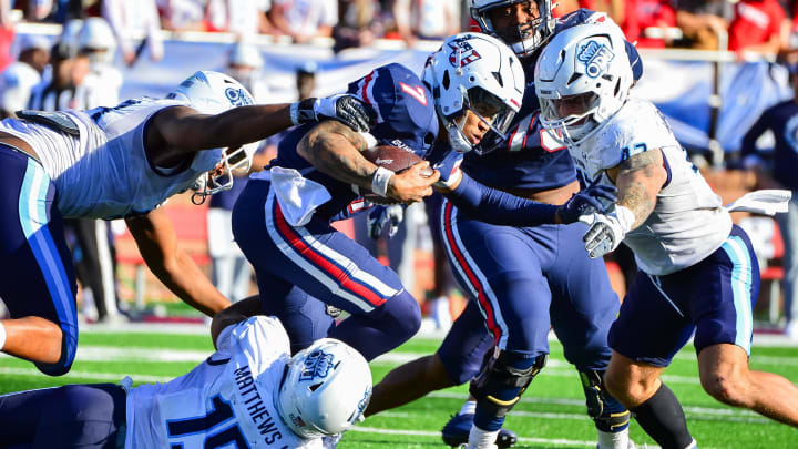 Nov 11, 2023; Lynchburg, Virginia, USA;  Liberty Flames quarterback Kaidon Salter (7) is tackled by Old Dominion Monarchs linebacker Wayne Matthews III (15) and Old Dominion Monarchs linebacker Jason Henderson (42) at Williams Stadium. Mandatory Credit: Brian Bishop-USA TODAY Sports