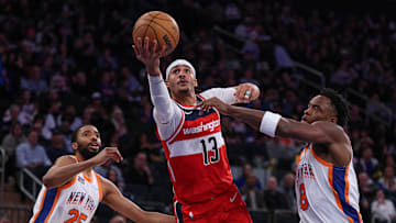 Mar 22, 2025; New York, New York, USA; Washington Wizards guard Jordan Poole (13) goes to the basket in front of New York Knicks forward Mikal Bridges (25) and forward OG Anunoby (8) during the second half at Madison Square Garden. Mandatory Credit: Vincent Carchietta-Imagn Images