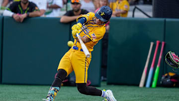 Jun 7, 2025; Charlotte, NC, USA; Savannah Bananas utility KJ Jackson (4) makes a hit during the exhibition game against the Party Animals at Bank of America Stadium. Mandatory Credit: Jim Dedmon-Imagn Images