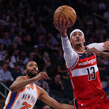 Mar 22, 2025; New York, New York, USA; Washington Wizards guard Jordan Poole (13) goes to the basket in front of New York Knicks forward Mikal Bridges (25) and forward OG Anunoby (8) during the second half at Madison Square Garden. Mandatory Credit: Vincent Carchietta-Imagn Images