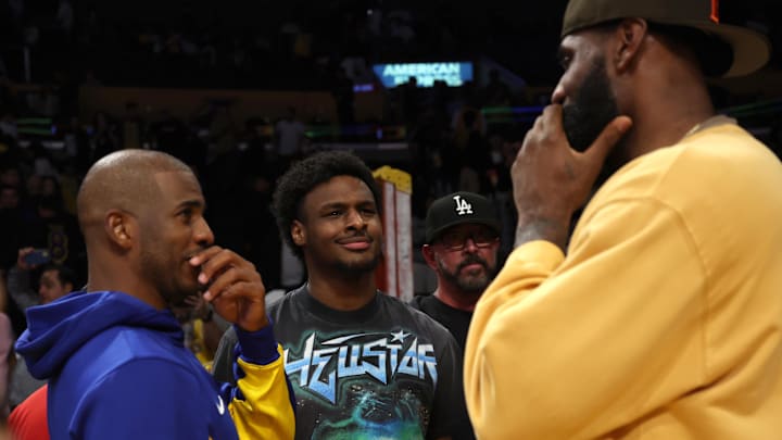 Oct 13, 2023; Los Angeles, California, USA; Golden State Warriors guard Chris Paul (3, left) talks with Los Angeles Lakers forward LeBron James (23, right) as LeBron's son Bronny (center) looks on after an NBA preseason basketball game at Crypto.com Arena. Mandatory Credit: Kiyoshi Mio-USA TODAY Sports Oct 13, 2023; Los Angeles, California, USA; Golden State Warriors guard Chris Paul (3, left) talks with Los Angeles Lakers forward LeBron James (23, right) as LeBron's son Bronny (center) looks on after an NBA preseason basketball game at Crypto.com Arena. Mandatory Credit: Kiyoshi Mio-USA TODAY Sports