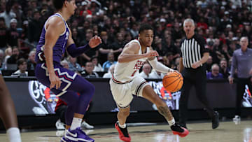 Jan 29, 2025; Lubbock, Texas, USA;  Texas Tech Red Raiders guard Chance McMillian (0) drives the ball against Texas Christian Horned Frogs guard Brendan Wenzel (0) in the second half at United Supermarkets Arena. Mandatory Credit: Michael C. Johnson-Imagn Images