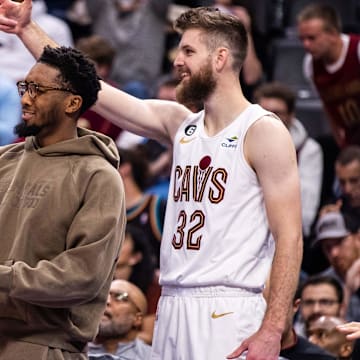 Nov 4, 2022; Detroit, Michigan, USA; Cleveland Cavaliers forward Evan Mobley (4), guard Donovan Mitchell (center) and forward Dean Wade (32) cheer on their team in the second quarter against the Detroit Pistons at Little Caesars Arena. Mandatory Credit: Allison Farrand-Imagn Images