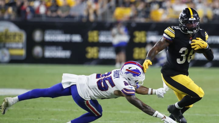 Aug 17, 2024; Pittsburgh, Pennsylvania, USA;  Pittsburgh Steelers running back La'Mical Perine (38) runs the ball against Buffalo Bills cornerback Daequan Hardy (25) during the third quarter at Acrisure Stadium. Buffalo won 9-3. Mandatory Credit: Charles LeClaire-USA TODAY Sports