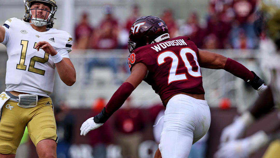 Oct 26, 2024; Blacksburg, Virginia, USA; Georgia Tech Yellow Jackets quarterback Aaron Philo (12) throws a pass against Virginia Tech Hokies linebacker Caleb Woodson (20) during the fourth quarter at Lane Stadium. Mandatory Credit: Peter Casey-Imagn Images Oct 26, 2024; Blacksburg, Virginia, USA; Georgia Tech Yellow Jackets quarterback Aaron Philo (12) throws a pass against Virginia Tech Hokies linebacker Caleb Woodson (20) during the fourth quarter at Lane Stadium. Mandatory Credit: Peter Casey-Imagn Images