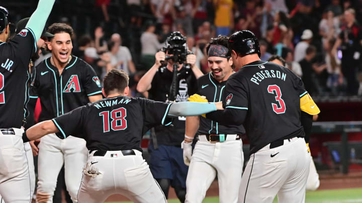 Jul 29, 2024; Phoenix, Arizona, USA;  Arizona Diamondbacks outfielder Corbin Carroll (7) celebrates with teammates after hitting a walk off home run in the ninth inning to beat the Washington Nationals at Chase Field. Mandatory Credit: Matt Kartozian-USA TODAY Sports