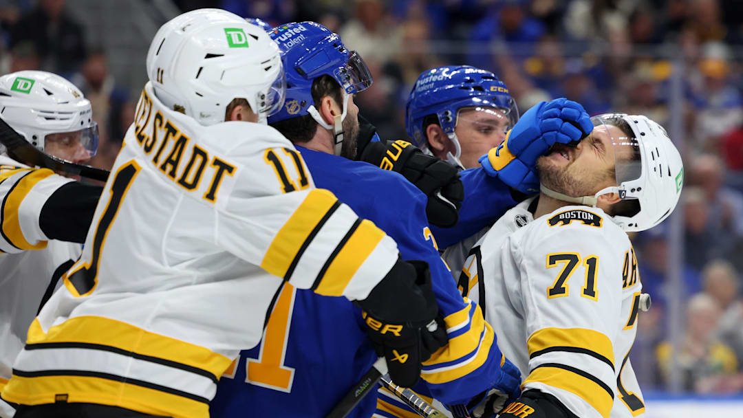Mar 25, 2026; Buffalo, New York, USA;  The Boston Bruins and the Buffalo Sabres players get into a scrum after the whistle during the first period at KeyBank Center. Mandatory Credit: Timothy T. Ludwig-Imagn Images