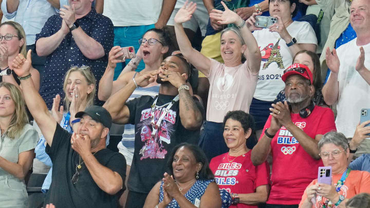 Bears safety Jonathan Owens, Nellie Biles, and Ronald Biles celebrates after Simone Biles won gold  in gymnastics all-around during the Paris 2024 Olympic Summer Games.