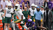 Oct 18, 2025; Fort Worth, Texas, USA; Baylor Bears tight end Michael Trigg (1) runs after the catch as he breaks the tackle attempt by TCU Horned Frogs linebacker Max Carroll (33) during the second half of a game at Amon G. Carter Stadium. Mandatory Credit: Raymond Carlin III-Imagn Images