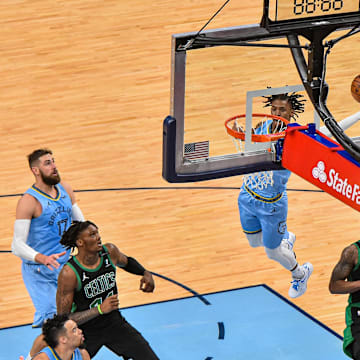 Memphis Grizzlies guard Ja Morant (12) dunks against Boston Celtics center Robert Williams (44) at FedExForum. 