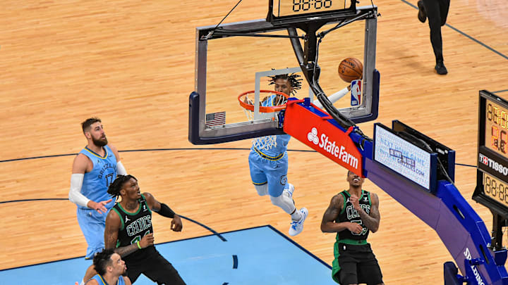 Memphis Grizzlies guard Ja Morant (12) dunks against Boston Celtics center Robert Williams (44) at FedExForum. 