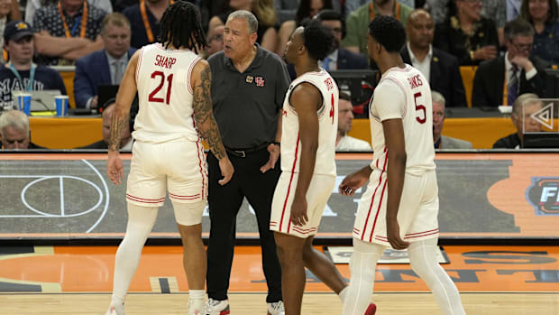 Houston Cougars players in white and coach Kelvin Sampso