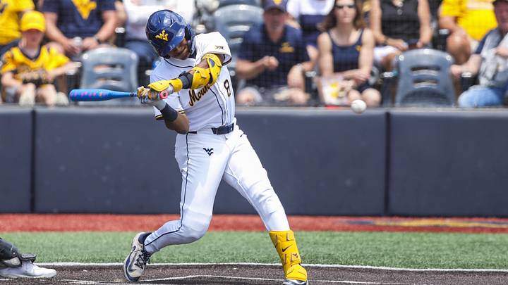 Jun 5, 2026; Morgantown, WV, USA; West Virginia Mountaineers infielder Tyrus Hall (8) hits a grand slam during the fourth inning against the Cal Poly Mustangs at Kendrick Family Ballpark. Mandatory Credit: Ben Queen-Imagn Images
