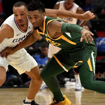 Jan 16, 2019; Los Angeles, CA, USA; Utah Jazz guard Donovan Mitchell (45) and LA Clippers guard Avery Bradley (11) chase a loose ball during the first half at Staples Center. Mandatory Credit: Kirby Lee-Imagn Images