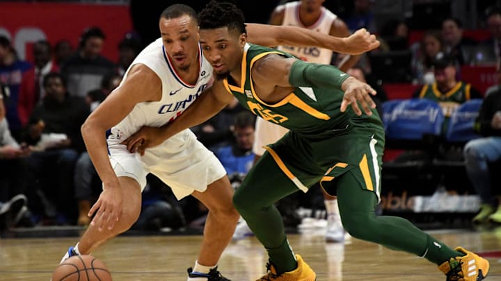 Jan 16, 2019; Los Angeles, CA, USA; Utah Jazz guard Donovan Mitchell (45) and LA Clippers guard Avery Bradley (11) chase a loose ball during the first half at Staples Center. Mandatory Credit: Kirby Lee-Imagn Images