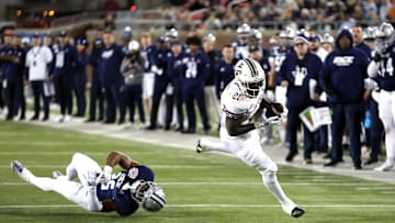 Dec 26, 2023; Dallas, TX, USA; Texas State Bobcats running back Ismail Mahdi (21) runs with the ball against Rice Owls defensive back AJ Stephens (25) in the second quarter at Gerald J Ford Stadium. Mandatory Credit: Tim Heitman-Imagn Images