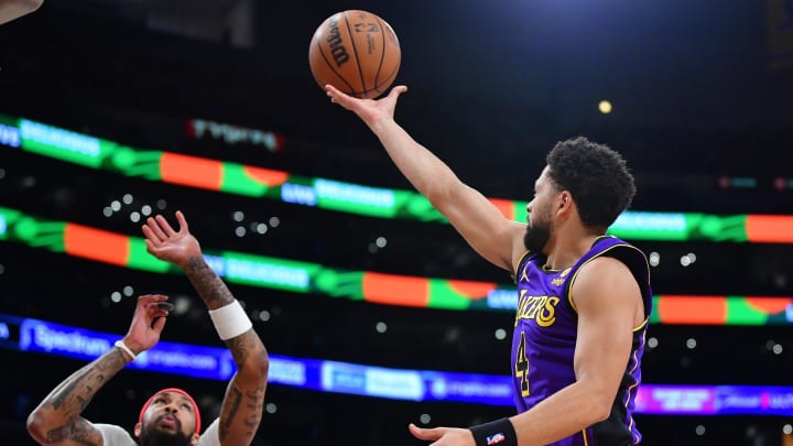 Feb 9, 2024; Los Angeles, California, USA; Los Angeles Lakers guard Skylar Mays (4) shoots against New Orleans Pelicans forward Brandon Ingram (14) during the first half at Crypto.com Arena. Mandatory Credit: Gary A. Vasquez-USA TODAY Sports