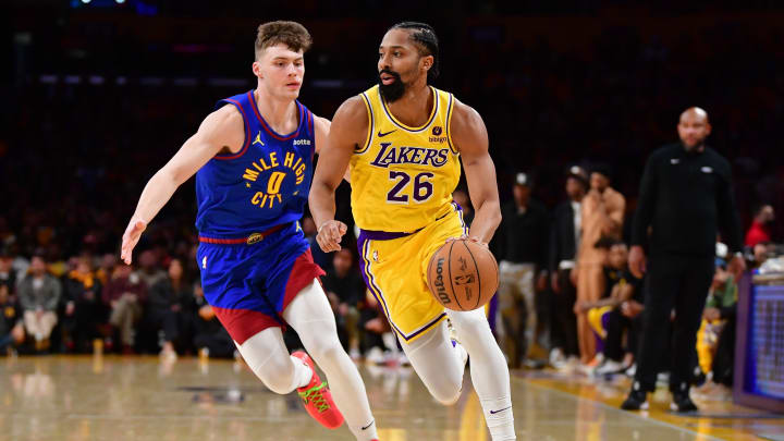 Apr 25, 2024; Los Angeles, California, USA; Los Angeles Lakers guard Spencer Dinwiddie (26) moves the ball ahead of Denver Nuggets guard Christian Braun (0) during the second half in game three of the first round for the 2024 NBA playoffs at Crypto.com Arena. Mandatory Credit: Gary A. Vasquez-USA TODAY Sports