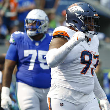 Sep 8, 2024; Seattle, Washington, USA; Denver Broncos defensive tackle D.J. Jones (93) celebrates a holding penalty against Seattle Seahawks guard Anthony Bradford (75) for a safety during the second quarter at Lumen Field. 