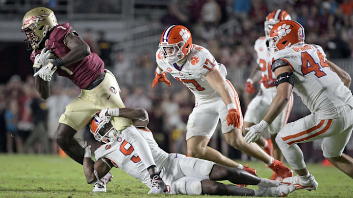 Oct 5, 2024; Tallahassee, Florida, USA; Clemson Tigers safety RJ Mickens (9) tackles Florida State Seminoles wide receiver Kentron Poitier (1) during the second half at Doak S. Campbell Stadium. Mandatory Credit: Melina Myers-Imagn Images Oct 5, 2024; Tallahassee, Florida, USA; Clemson Tigers safety RJ Mickens (9) tackles Florida State Seminoles wide receiver Kentron Poitier (1) during the second half at Doak S. Campbell Stadium. Mandatory Credit: Melina Myers-Imagn Images